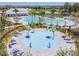 Community splash pad with lounge chairs and umbrellas at 32527 Harmony Oaks Dr, Wesley Chapel, FL 33545