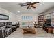 Living room with hardwood floors, a sofa, a coffee table, and built-in shelving at 2344 Glenmore Cir, Sun City Center, FL 33573