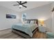 Spacious bedroom with a comfortable bed, nightstands, and ceiling fan at 16443 Strauss Ave, Port Charlotte, FL 33954