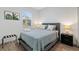 Guest bedroom with a full-size bed, gray bedding, and a window with blinds at 16443 Strauss Ave, Port Charlotte, FL 33954