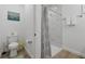 Clean bathroom with toilet and shower, featuring marble-style tiles at 16443 Strauss Ave, Port Charlotte, FL 33954