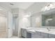 Contemporary bathroom with double sinks, a large mirror, and access to walk-in closet at 157 Hidden Estates Ct, Brandon, FL 33511