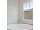 Modern bathroom features a standalone tub with a view from the window at 157 Hidden Estates Ct, Brandon, FL 33511