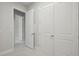 Hallway with multiple white doors, light flooring and neutral walls, providing a bright and airy feel at 157 Hidden Estates Ct, Brandon, FL 33511