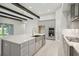 A modern kitchen features a large island, stainless steel appliances, and gray cabinets at 157 Hidden Estates Ct, Brandon, FL 33511
