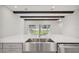 Kitchen featuring a stainless steel sink, white countertops and a view of the spacious backyard at 157 Hidden Estates Ct, Brandon, FL 33511