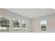 Bright living room with large windows providing ample natural light and views of the yard at 157 Hidden Estates Ct, Brandon, FL 33511