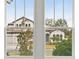 Neighborhood home seen through a double-hung window at 157 Hidden Estates Ct, Brandon, FL 33511