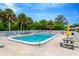 Inviting community pool with surrounding patio furniture and lush landscaping at 4936 Hazner St, New Port Richey, FL 34652