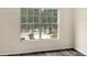 Bedroom with large window and wood-look floors at 10137 Haverhill Ridge Dr, Riverview, FL 33578