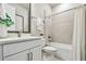 Clean bathroom featuring a vanity with tub-shower combo and neutral tile, a functional space at 652 Allora Ave, Nokomis, FL 34275