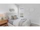 Cozy bedroom featuring a comfortable bed with neutral decor, a side table, and soft natural light at 652 Allora Ave, Nokomis, FL 34275