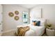 Cozy bedroom with decorative accents and a sunlit window, offering a relaxing retreat at 652 Allora Ave, Nokomis, FL 34275
