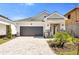 Beautiful single-story home featuring a paved driveway, a gray two-car garage, and well-manicured landscaping at 652 Allora Ave, Nokomis, FL 34275
