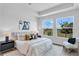 Serene main bedroom with natural light, plush bedding, and stylish decor creating a relaxing retreat at 652 Allora Ave, Nokomis, FL 34275