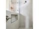 Modern tiled shower showcases a built-in niche and glass enclosure, offering a spa-like experience at 652 Allora Ave, Nokomis, FL 34275