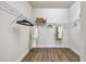Organized walk-in closet featuring wire shelving and wood-look floors for a functional and stylish space at 652 Allora Ave, Nokomis, FL 34275