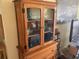 Wooden hutch with glass doors and storage at 115 112Th Ne Ave # 605, St Petersburg, FL 33716