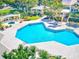 Community pool with surrounding patio and landscaping at 115 112Th Ne Ave # 605, St Petersburg, FL 33716