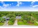 Aerial view of a house community showing multiple homes, landscaping, and a glimpse of a lake at 239 147Th Ne St, Bradenton, FL 34212