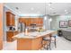 Modern kitchen featuring granite countertops, wood cabinets, and an island with seating at 239 147Th Ne St, Bradenton, FL 34212