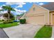 Front view of the two-car garage, driveway, and landscaping at 3602 Pine Knot Dr, Valrico, FL 33596