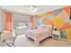 Charming bedroom with geometric accent wall and ample natural light at 3602 Pine Knot Dr, Valrico, FL 33596