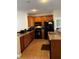 Modern kitchen with dark appliances and wood cabinets at 3464 Silverstone Ct, Plant City, FL 33566