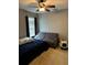 Bedroom with a couch, large bed, and ceiling fan at 3464 Silverstone Ct, Plant City, FL 33566