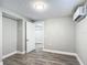 Cozy bedroom featuring grey walls, wood-look flooring, and a door to another room at 3128 17Th N St, St Petersburg, FL 33713