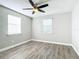 Bright bedroom with wood-look floors, ceiling fan, and window blinds at 3128 17Th N St, St Petersburg, FL 33713