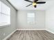 Bright bedroom with wood-look floors, ceiling fan, and window blinds at 3128 17Th N St, St Petersburg, FL 33713