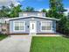 Newly renovated home with light gray exterior, inviting front yard and fresh landscaping at 3128 17Th N St, St Petersburg, FL 33713