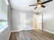Bedroom with wood-look floors, ceiling fan, and window blinds at 3128 17Th N St, St Petersburg, FL 33713