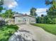 Newly renovated home with light gray exterior, inviting front yard and fresh landscaping at 3128 17Th N St, St Petersburg, FL 33713