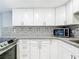 Modern kitchen featuring white cabinets, granite countertops, and stainless steel appliances at 3128 17Th N St, St Petersburg, FL 33713