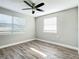 Bright bedroom with wood-look floors, ceiling fan, and window blinds at 3128 17Th N St, St Petersburg, FL 33713