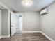 Bright bedroom with grey walls, wood-look flooring, and a door to another room at 3128 17Th N St, St Petersburg, FL 33713