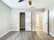 Bedroom with wood-look floors, closet, and additional room access at 3128 17Th N St, St Petersburg, FL 33713