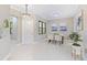 Bright dining room with a glass table, neutral decor, and kitchen view at 2847 Tarragona Way, Wesley Chapel, FL 33543