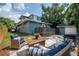 Lovely backyard with patio, modern outdoor furniture, green grass, and storage shed at 1203 E 33Rd Ave, Tampa, FL 33603