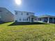 Large grassy backyard with a view of the home's back elevation at 18207 Fattoria Ter, Lakewood Ranch, FL 34211