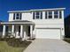 Two-story home with white siding, dark gray shutters, and a two-car garage at 18207 Fattoria Ter, Lakewood Ranch, FL 34211