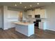Modern kitchen featuring white cabinets, an island, and stainless steel appliances at 18207 Fattoria Ter, Lakewood Ranch, FL 34211