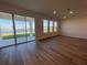 Spacious living room with sliding glass doors leading to a patio and lake view at 18207 Fattoria Ter, Lakewood Ranch, FL 34211