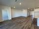 Spacious living area with wood-look flooring and access to other rooms at 18223 Fattoria Ter, Bradenton, FL 34211