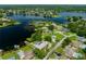 Panoramic aerial view of a lakefront community featuring lush landscaping and serene water views at 3744 E Lake Dr, Land O Lakes, FL 34639
