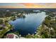 Aerial view of lakeside homes nestled amidst lush greenery with private boat docks at 3744 E Lake Dr, Land O Lakes, FL 34639