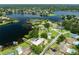 Expansive aerial view of a lake community with multiple homes, docks, and lush surroundings at 3744 E Lake Dr, Land O Lakes, FL 34639