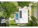 Stunning aerial view of home with screened pool, dock, lush landscaping and a backyard ready for entertaining at 3744 E Lake Dr, Land O Lakes, FL 34639